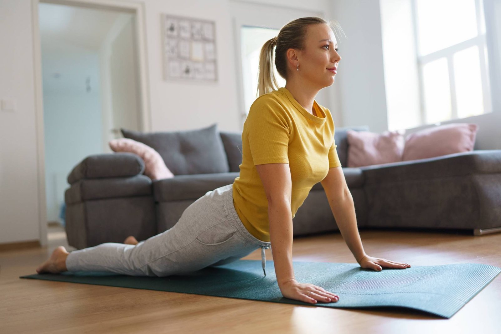 Woman exercising at home, stretching her body. Solo home workout and meditation, morning or evening workout routine. Wom